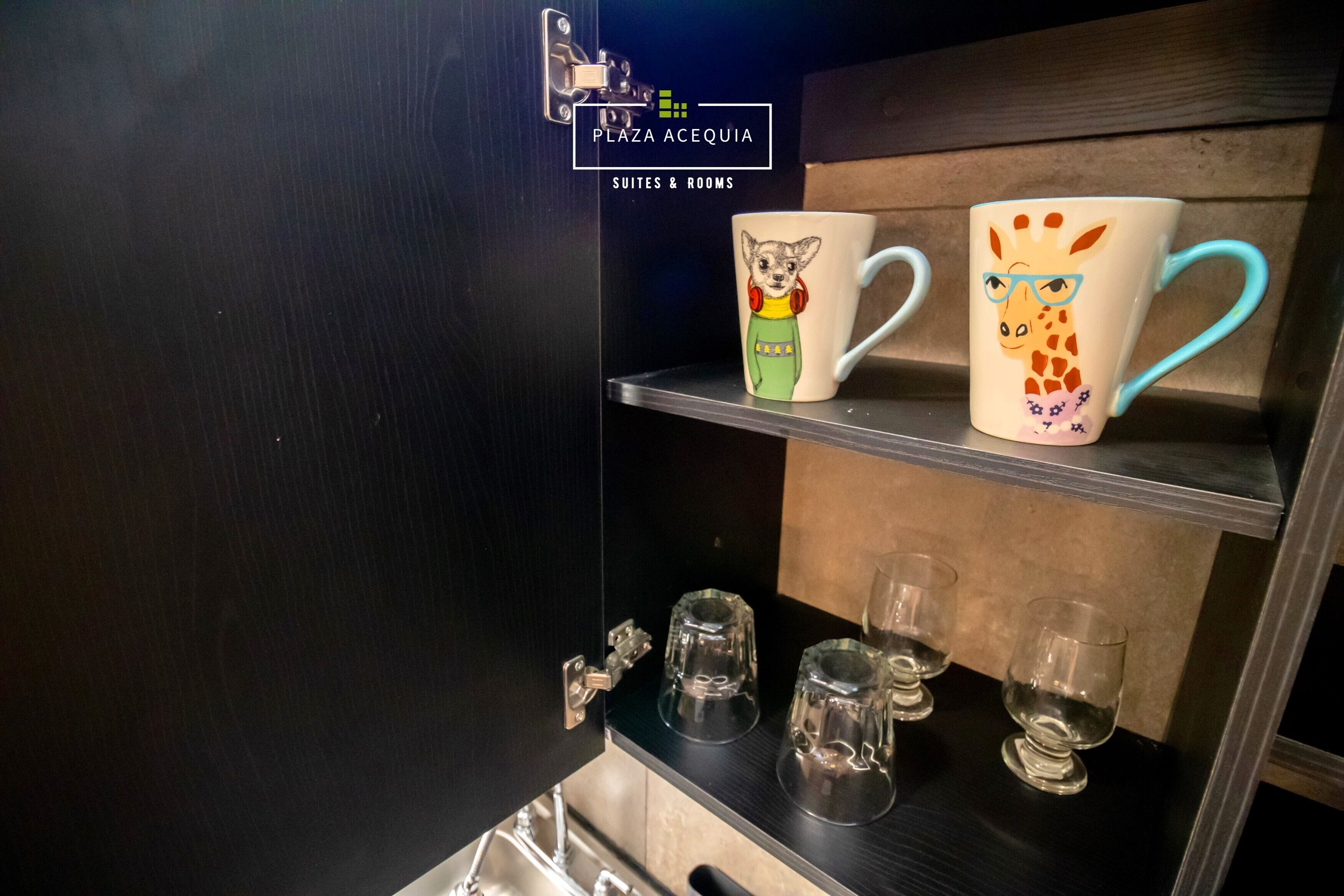 A shelf with two mugs and three glasses.