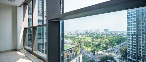 A high-rise building with a view of a cityscape and a park.