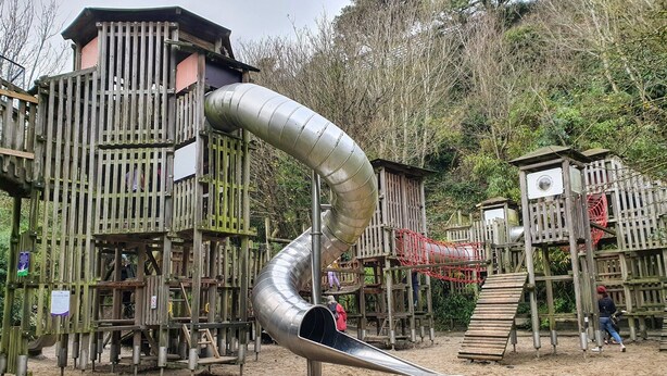 A playground with a large slide and wooden play structures. - 1-Bedroom Apartment Sleeps 4, Parking (Hythe)
