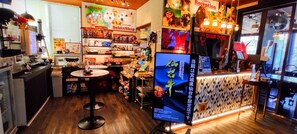 A pet store interior with shelves stocked with pet food and toys, a reception area, and a counter with a menu. - hakonegora guamdog honten (Hakone)