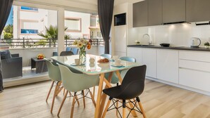 A modern kitchen with white cabinets, a black microwave, and a kettle on the counter. - Picigin by Interhome (Zadar/Bibinje)