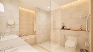 A modern bathroom with a glass-enclosed shower, a white toilet, and a vanity with a mirror and sink. - Ondus Boracay (Boracay Island)