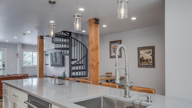 A modern kitchen with a central island, stainless steel sink, and pendant lighting. - 3BR with Mountain Views on FREE Bus Line (Breckenridge)