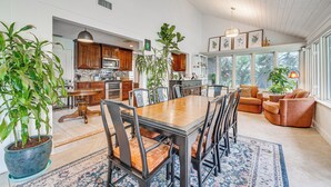 A spacious kitchen with wooden cabinets and a dining area with a large table and chairs. - 10 Mi to Disney World, Lakeside Orlando Getaway (Orlando)