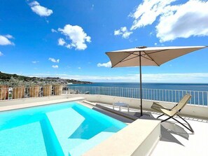 A swimming pool with a clear view of the ocean and a beach in the background. - Villa Core: A bright and sunny independent house which faces the sun and the sea, with Free WI-FI. (Diso)