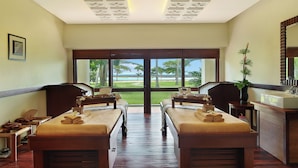 A room with two beds, a large window, a sink, and a mirror. - Manado Tateli Resort and Convention (Pineleng)