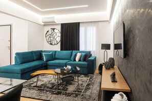 Signature Apartment | Living area | 55-inch Smart TV with cable channels, MP3 dock