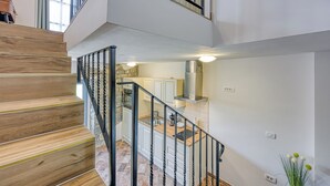 A modern kitchen with white cabinets, a wooden countertop, and a black railing. - Istrian Casa Pr Marici Relaxing Vineyard (Koper)