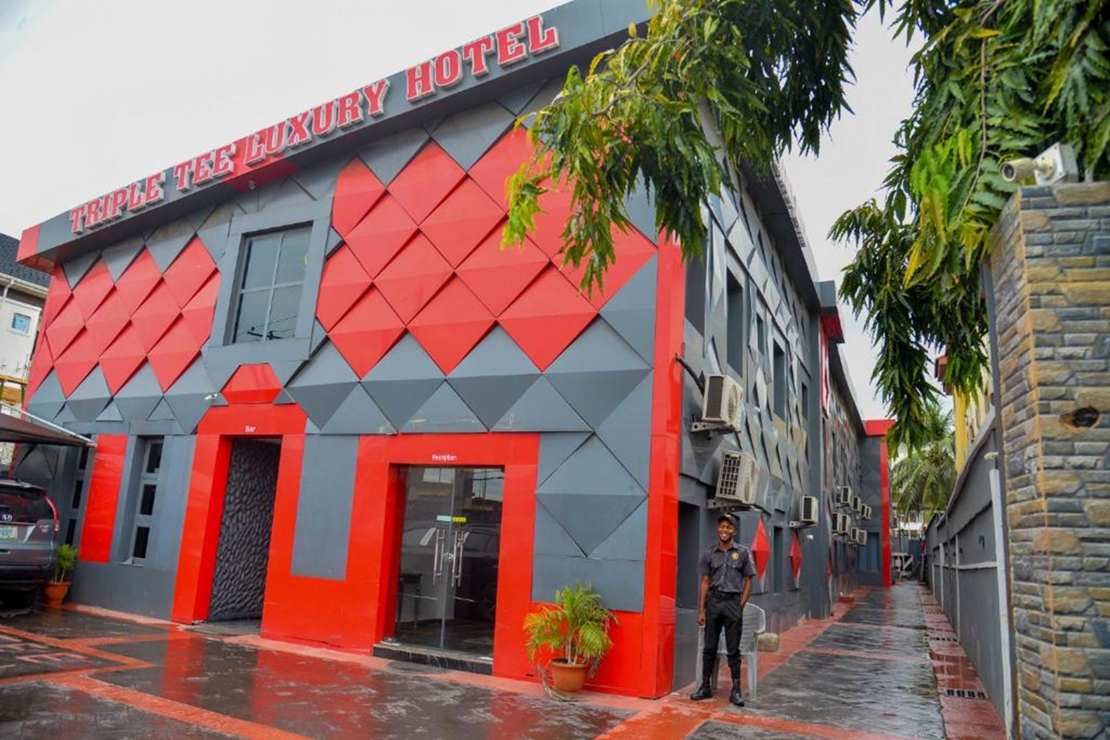 A hotel with a modern facade featuring geometric patterns and a prominent reception area.
