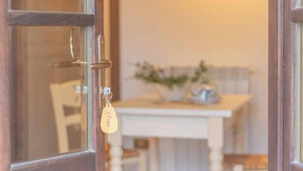 A wooden door with a keyhole and a key hanging on the door handle. - Comfortable and essential for a carefree stay
 (Lazio)