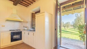 A kitchen with white cabinets, a black oven, and a gas stove. - Comfort and attention to detail for a stay in the country
 (Lazio)