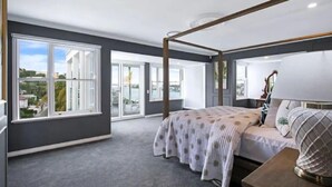 A bedroom with a four-poster bed, large windows, and a view of the outside. - Brisbane Hamilton Hill With Panorama View (Hamilton)