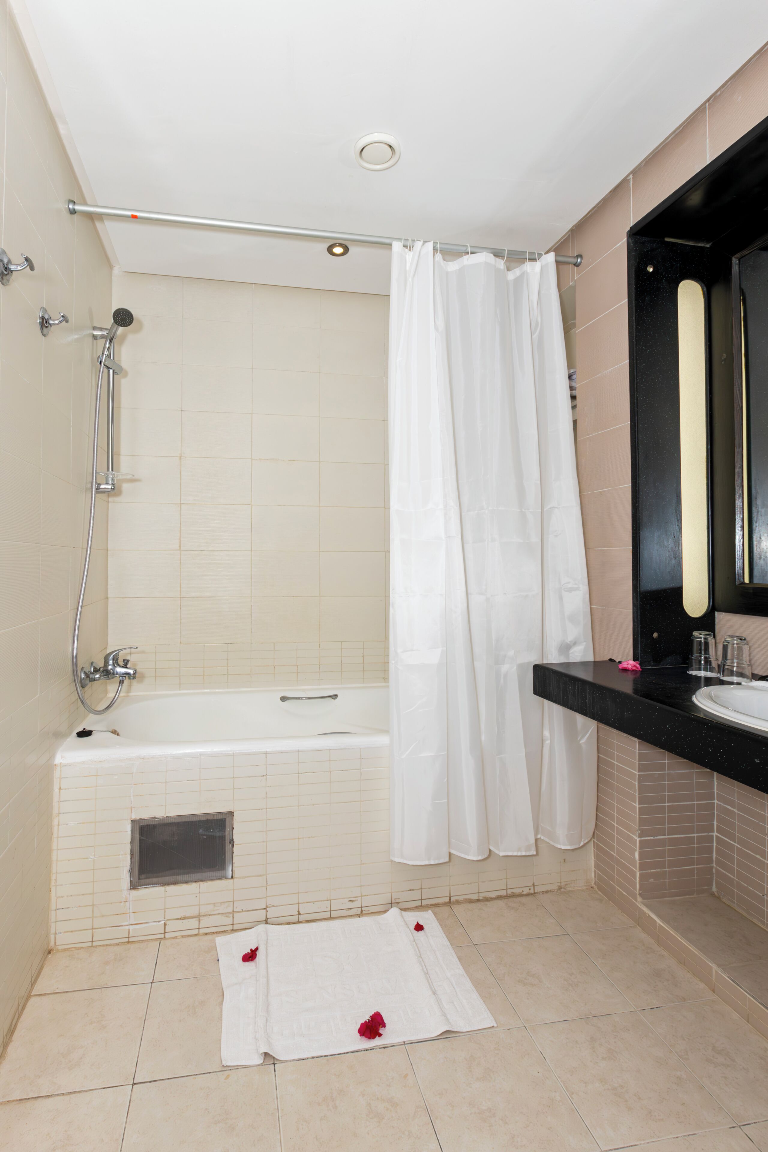 Bathtub, hair dryer, bathrobes, towels