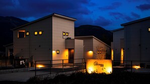 A modern building with multiple entry points and a well-lit entrance area.