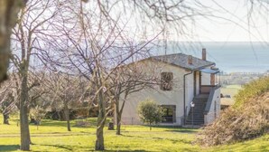 A single-story house with a sloped roof, a small porch, and a staircase leading to the entrance. - Comfort and attention to detail for an exceptional stay
 (Lazio)