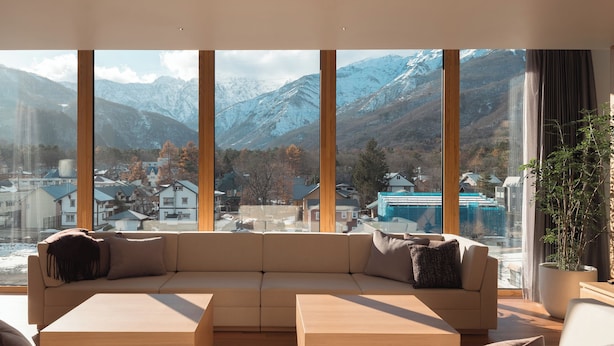 A modern living room with a large window offering a mountain view. - HOTEL LA VIGNE HAKUBA by Onko Chishin (Hakuba)