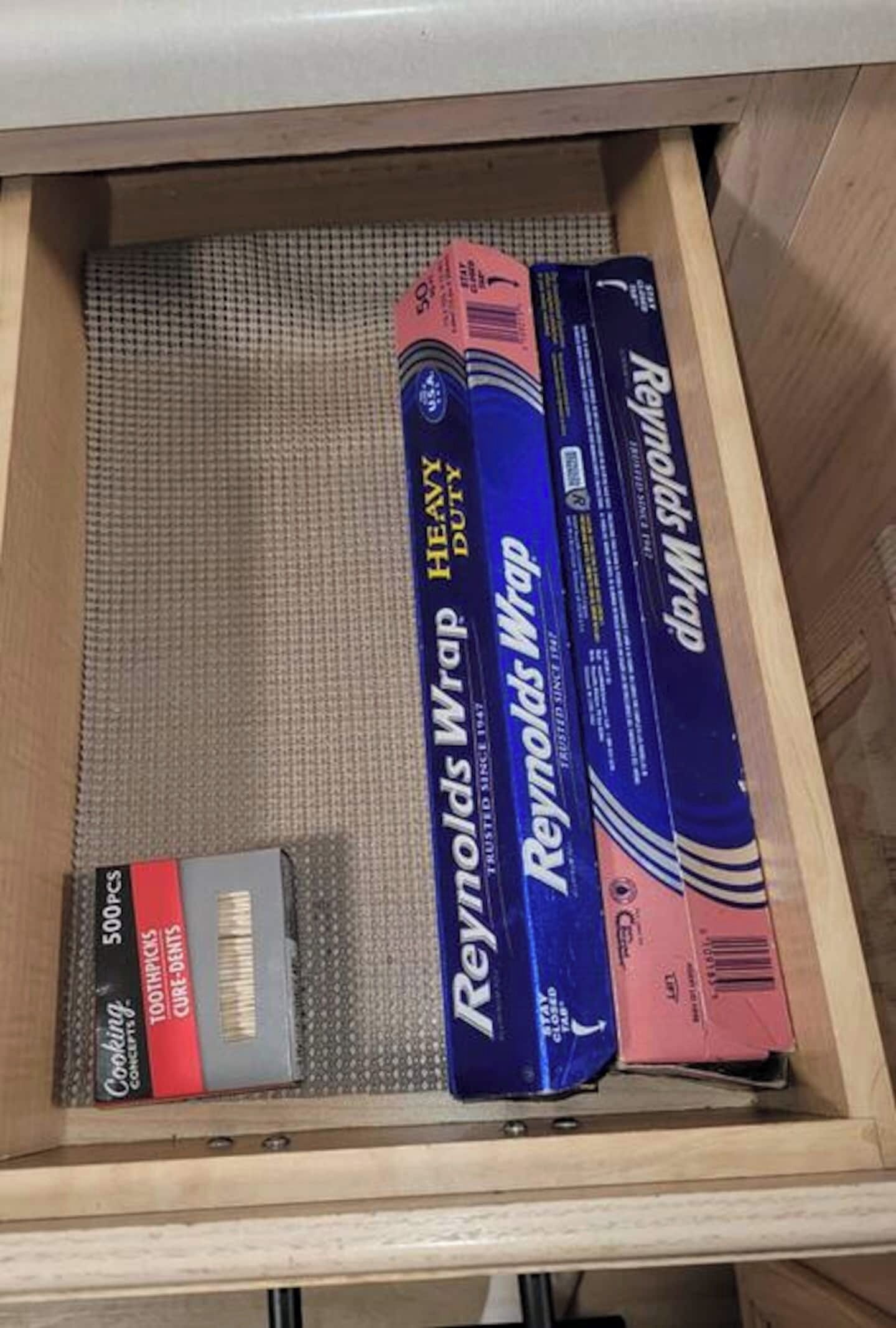 A drawer containing various items including a box labeled 'Reynolds Wrap Heavy Duty', a '500p' box, and a 'Cooking Concepts' box.