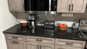A kitchen with a microwave, coffee maker, toaster, and cabinets. - Great vacation home for your next adventure. Located in Andrew’s North Carolina. (Andrews)