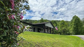 A house with a porch, surrounded by a grassy lawn and trees. - Great vacation home for your next adventure. Located in Andrew’s North Carolina. (Andrews)