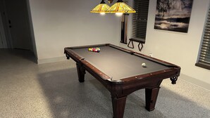 A pool table with a lamp, pool balls, and a framed picture on the wall. - Great vacation home for your next adventure. Located in Andrew’s North Carolina. (Andrews)