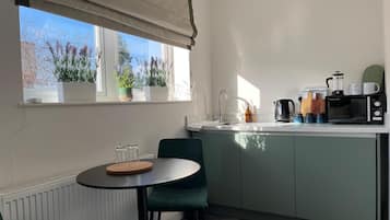 Deluxe Room | Private kitchen | Coffee/tea maker, highchair, eco-friendly cleaning products