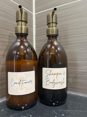 Two bottles of conditioner and shampoo on a bathroom counter. - The Briarcroft Wayth Hotels (Goole)