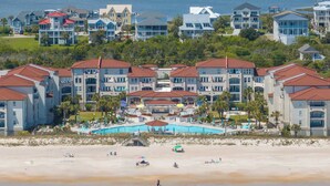 A beachfront hotel with multiple buildings, a swimming pool, and a beach. - Villa Capriani 102B - Oceanfront - Pools - Restaurant - Premiere (North Topsail Beach)