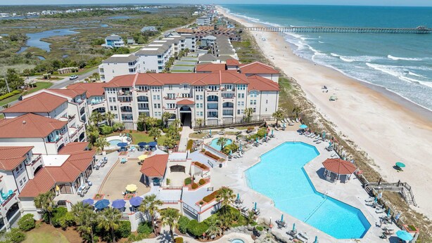 A resort with multiple buildings, a large swimming pool, and a beach. - Villa Capriani 102B - Oceanfront - Pools - Restaurant - Premiere (North Topsail Beach)