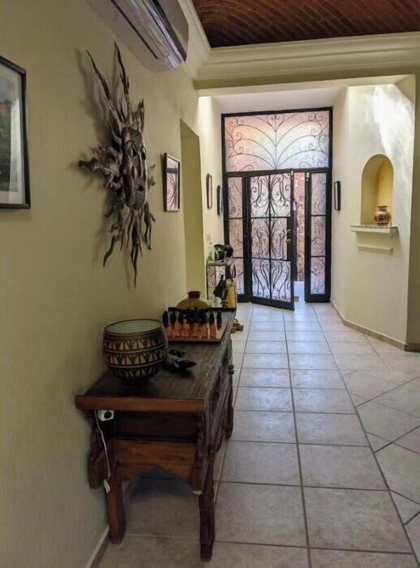 Enter a tranquil space with a wrought iron gate, adorned with framed artwork and decorative touches.