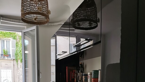 A modern kitchen with a large window, a microwave, a toaster, and a hanging basket. - Bienvenue à Paris 19 :) (Paris)