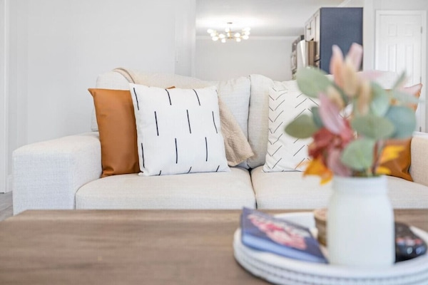 Relax in the spacious living room with comfortable seating and plenty of natural light.