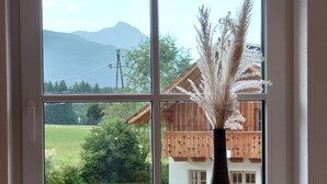 A window with a view of a house and mountains. - Alpinest - Chalet Speiereck 1 (Mariapfarr)