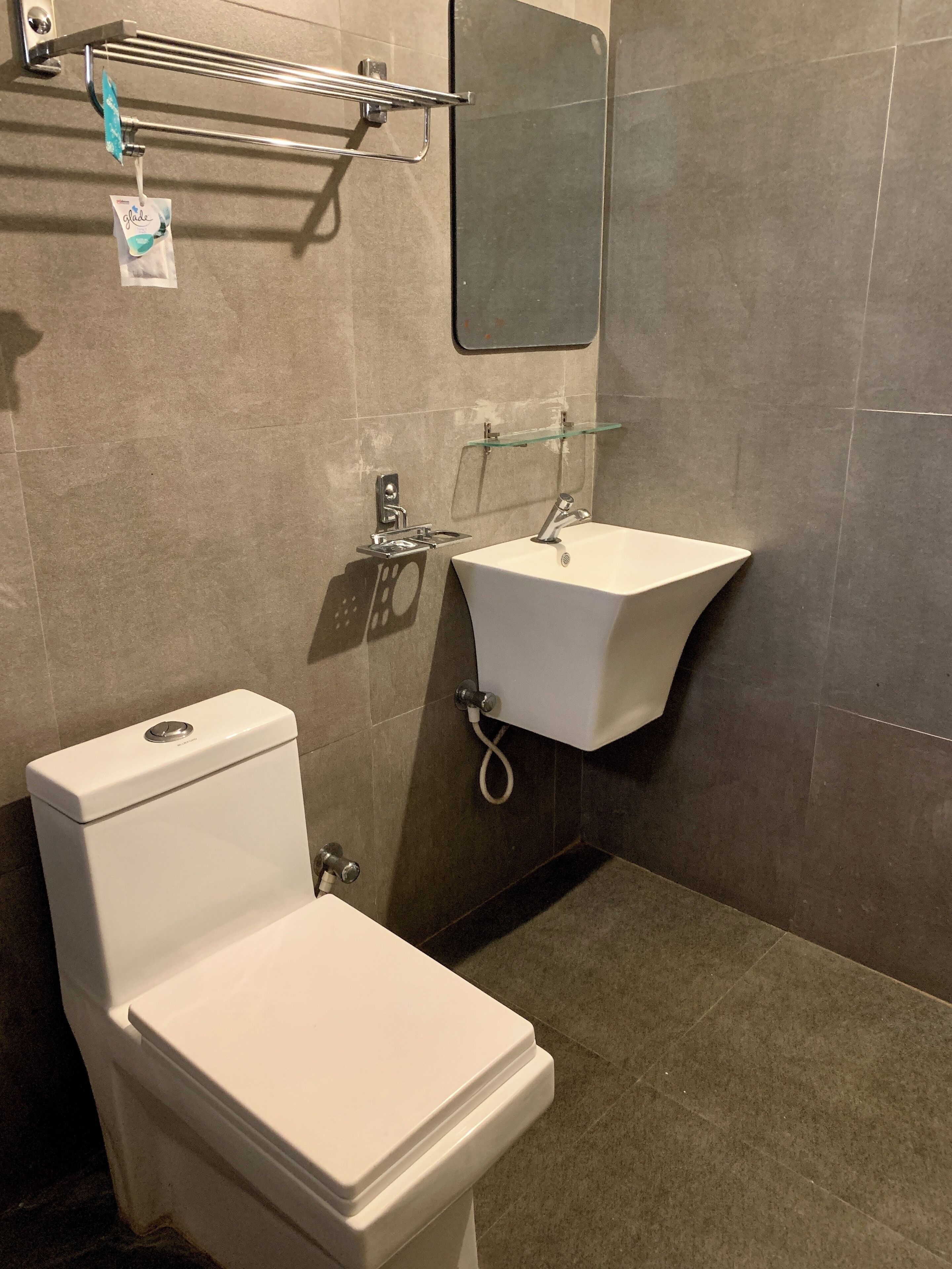 A bathroom with a toilet, sink, and shower.