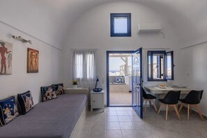 Deluxe Apartment | Living area | TV - Panoramic Argyro's IO House with Jacuzzi (Santorini)