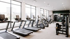 A gym with treadmills, elliptical machines, and weight machines. - Landing | Incredible 1BD, Courtyard, Gym (Kansas City)