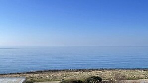 A coastal view with a clear sky and calm sea.