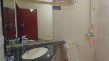 A bathroom with a sink, toilet, and shower.