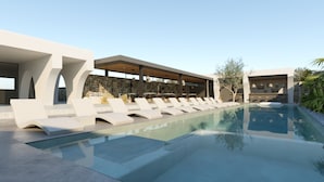 A modern pool area with lounge chairs and a bar area. - Ios Bliss (Ios)