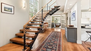 A modern staircase with wooden steps and metal railings, leading to an upper floor. - Family-Friendly East Aspen Retreat with Hot Tub, Views & Minutes to Downtown (Aspen)