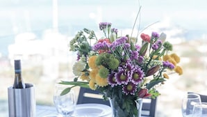 A table set for dining with a vase of flowers in the center.