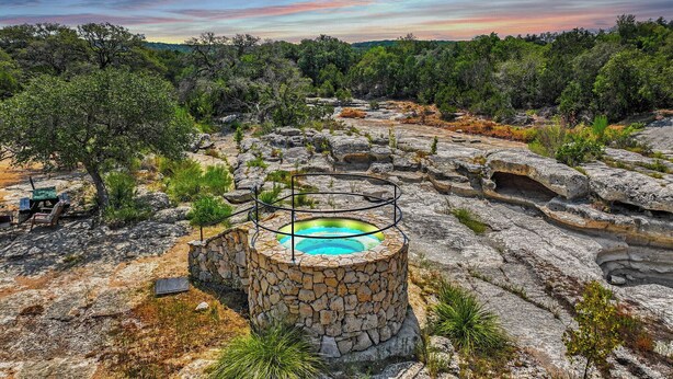 A natural hot spring surrounded by rocky terrain and trees. - Expansive Hill Country Ranch w/ Pool Access on 2,001 Acres (Johnson City)