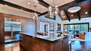 A modern kitchen with a large island, stainless steel appliances, and wooden cabinetry. - Chic Colony Ski-in Ski Out Villa Direct Access to Adventures at Park City Resort Hot Tub Gym (Park City)