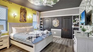 A bedroom with a bed, a ceiling fan, a wardrobe, and a television. - Themed 8BR | Arcade | 2 Theaters | Pool & Spa (Kissimmee)