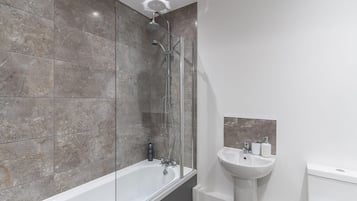 Shower, hair dryer, towels, shampoo