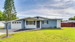 A single-story house with a front garage, a small porch, and a well-maintained lawn. - Game Room, Private Pool: South Daytona Home! (Daytona Beach)