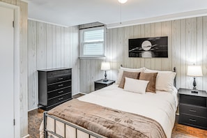 A bedroom with a bed, two nightstands, a dresser, a window, and a wall-mounted artwork. - Family-friendly Home < 5 Mi to Downtown Nashville (Nashville)