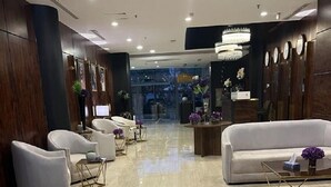 A modern lobby with a marble floor, white sofas, and a chandelier. - The S Hotel (Jeddah)