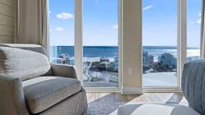 A spacious living room with a large window offering a view of the beach and ocean. - Mustique 802- Luxury Condo with Direct Gulf View a (Gulf Shores)