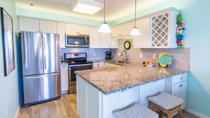 A kitchen with white cabinets, stainless steel appliances, a granite countertop, and two bar stools. - Gulf View, Community Pool, Tennis, Beach Access (Santa Rosa Beach)