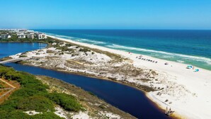 A coastal area with a beach, a bridge, and a body of water. - Golf Cart, 30A Watersound Gated Community, Beach Views, Gulf Front, Large Pool (Inlet Beach)
